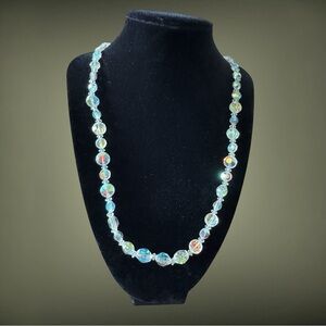 Clear glass beaded necklace. Non branded. Pre-Owned. Colors reflect off of it.